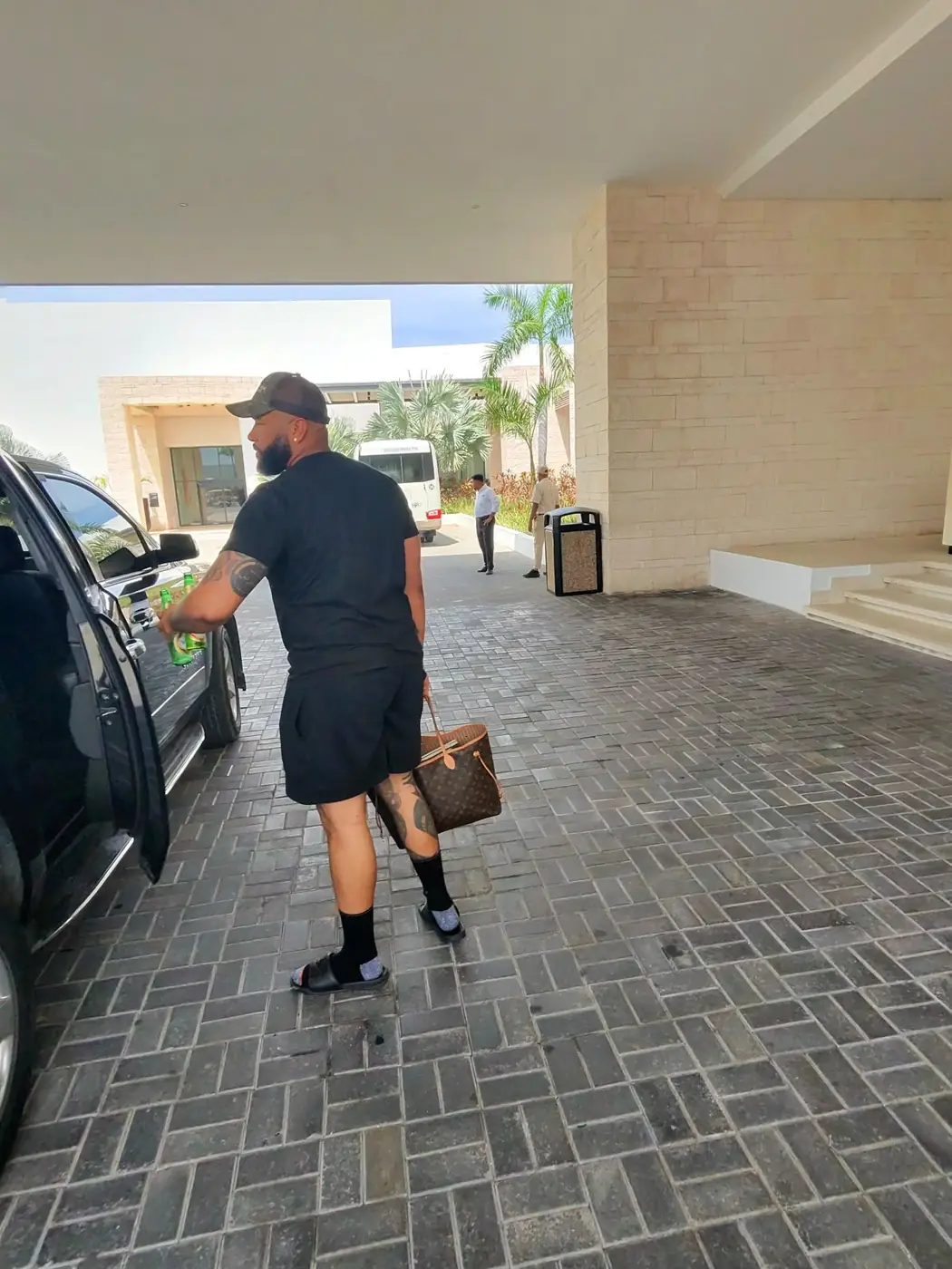 A traveler walking to his private SUV
